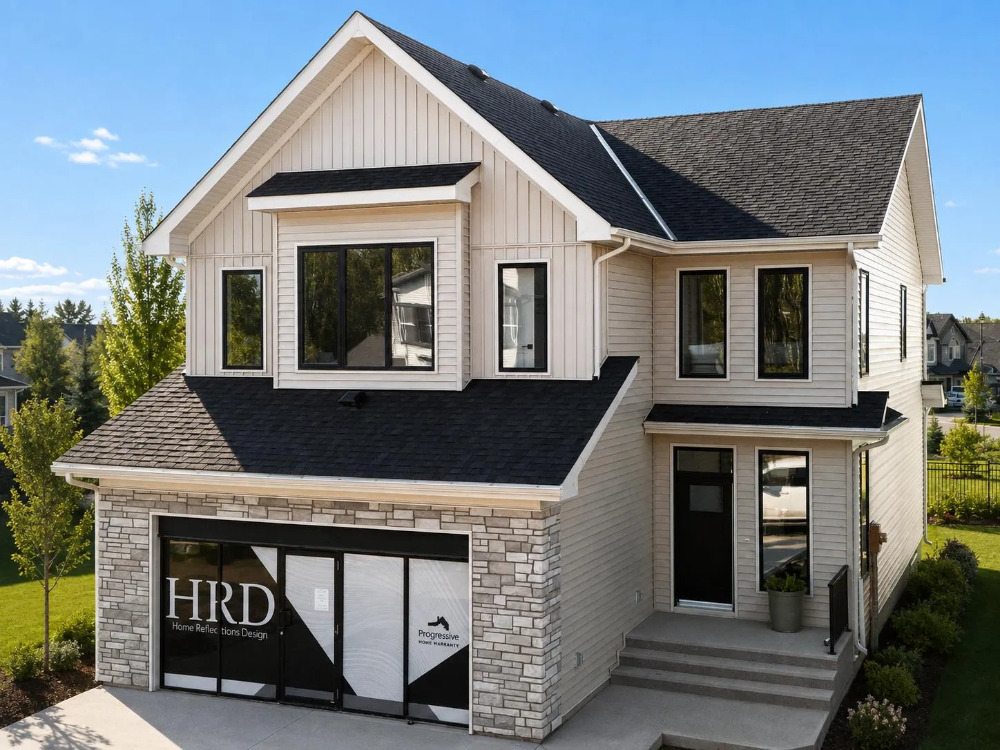 Fern showhome with a gabled roof, light siding and stone garage